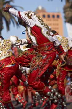 Male Caporales dancer in ornate costume performing at the annual Carnaval Andino con la Fuerza del Sol in Arica, Chile.