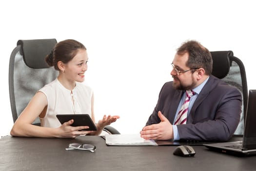 partners exchange words sitting at a table