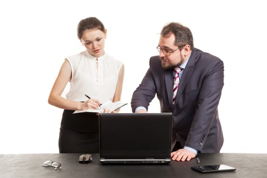 partners conduct negotiations facing a table and look at the laptop