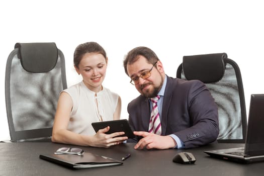 partners conduct negotiations sitting at a table and look at the tablet