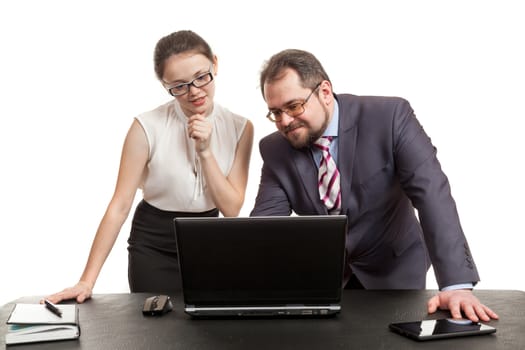 partners conduct negotiations facing a table and look at the laptop