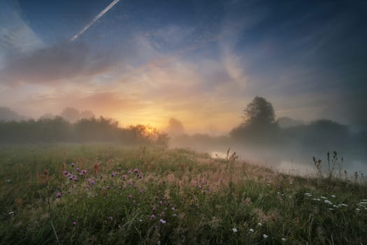 Summer sunrise. July dawn. Figgy sunrise on the river in Belarus