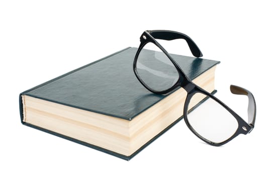 Book with glasses isolated on white background, close up view
