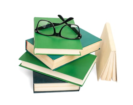 Pile of books with eyeglasses isolated on white background