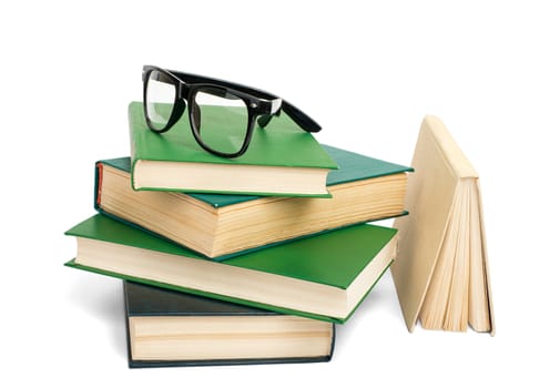 Pile of books with eyeglasses isolated on white background