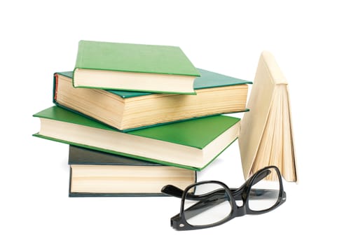 Pile of books with glasses isolated on white background, closeup