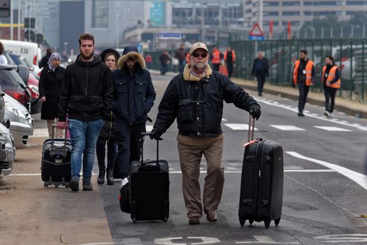 BELGIUM, Brussels: Passengers leave Brussels airport, on March 22, 2016 in Zaventem , following its evacuation after at least 13 people were killed and 35 injured as twin blasts rocked the main terminal of Brussels airport.