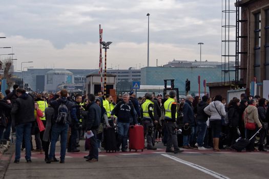 BELGIUM, Brussels: Passengers leave Brussels airport, on March 22, 2016 in Zaventem , following its evacuation after at least 13 people were killed and 35 injured as twin blasts rocked the main terminal of Brussels airport.