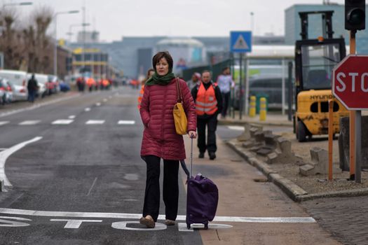 BELGIUM, Brussels: Passengers leave Brussels airport, on March 22, 2016 in Zaventem , following its evacuation after at least 13 people were killed and 35 injured as twin blasts rocked the main terminal of Brussels airport.