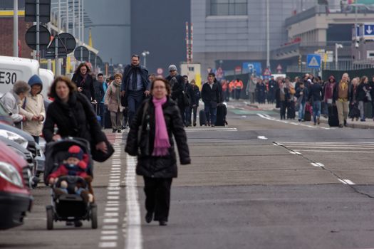 BELGIUM, Brussels: Passengers leave Brussels airport, on March 22, 2016 in Zaventem , following its evacuation after at least 13 people were killed and 35 injured as twin blasts rocked the main terminal of Brussels airport.