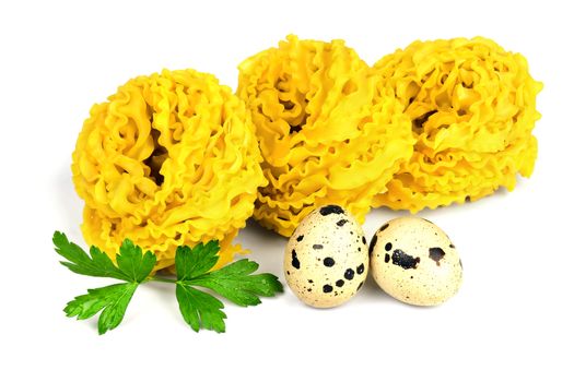 Italian raw curly fettuccine pasta with two quail eggs and parsley isolated on white background.