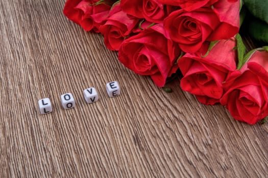 White cubes as a inscription love on a wooden background