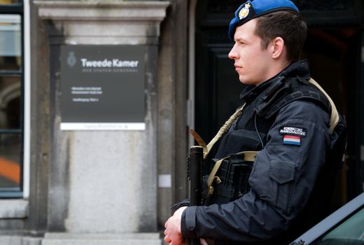 NETHERLANDS, the Hague: A member of the Royal Military Police stands by as the Hague, the Netherlands is on high alert following the deadly attacks in Brussels, Belgium on March 22, 2016. The attacks, at least one of which was carried out by a suicide bomber, left at least 30 dead at Zaventem airport and Maelbeek metro station.