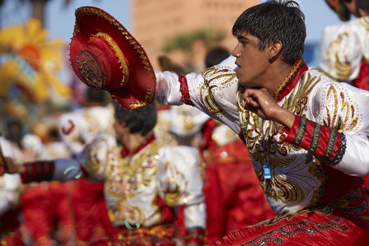 Male Caporales dancer in ornate costume performing at the annual Carnaval Andino con la Fuerza del Sol in Arica, Chile.