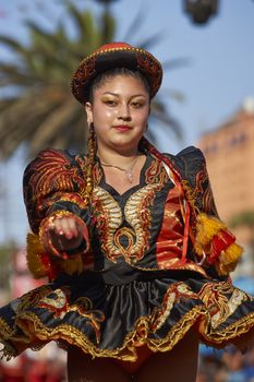 Caporales dancers in ornate costumes performing at the annual Carnaval Andino con la Fuerza del Sol in Arica, Chile.