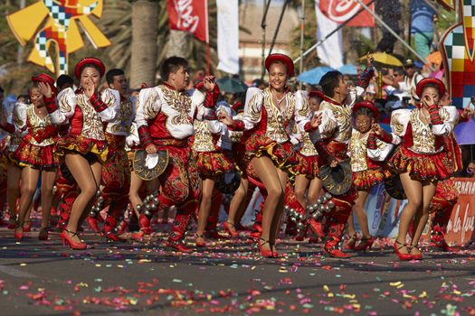 Caporales dancers in ornate costumes performing at the annual Carnaval Andino con la Fuerza del Sol in Arica, Chile.