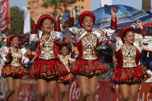 Caporales dancers in ornate costumes performing at the annual Carnaval Andino con la Fuerza del Sol in Arica, Chile.