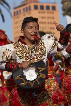 Male Caporales dancer in ornate costume performing at the annual Carnaval Andino con la Fuerza del Sol in Arica, Chile.