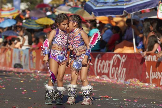 Young girls dressed as Tobas dancers in traditional Andean costumes performing at the annual Carnaval Andino con la Fuerza del Sol in Arica, Chile.