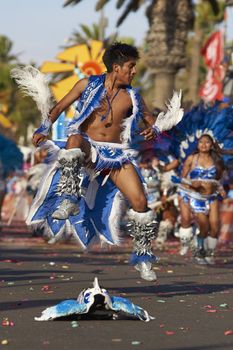 Tobas dancer in traditional Andean costume performing at the annual Carnaval Andino con la Fuerza del Sol in Arica, Chile.