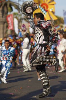 Caporales dancers in traditional Andean costume performing at the annual Carnaval Andino con la Fuerza del Sol in Arica, Chile.