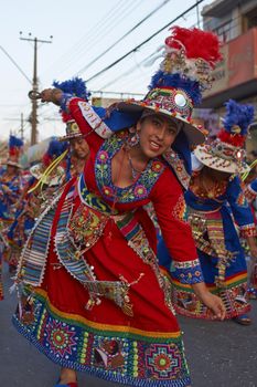 Tinku dancing group in colourful costumes performing a traditional ritual dance as part of the Carnaval Andino con la Fuerza del Sol in Arica, Chile.