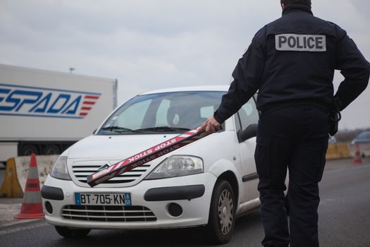 FRANCE, Neuville-en-Ferrain: French police officer checks vehicles at the French-Belgian border, near Neuville-en-Ferrain, northern France, on March 22, 2016 , as security measures have been reinforced after a series of apparently coordinated explosions ripped through Brussels airport and a metro train on Tuesday, killing at least 26 people in the latest attacks to target Europe.