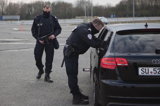 FRANCE, Neuville-en-Ferrain: French police officers check vehicles at the French-Belgian border, near Neuville-en-Ferrain, northern France, on March 22, 2016 , as security measures have been reinforced after a series of apparently coordinated explosions ripped through Brussels airport and a metro train on Tuesday, killing at least 26 people in the latest attacks to target Europe.