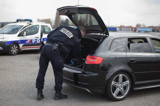FRANCE, Neuville-en-Ferrain: French police officer checks vehicles at the French-Belgian border, near Neuville-en-Ferrain, northern France, on March 22, 2016 , as security measures have been reinforced after a series of apparently coordinated explosions ripped through Brussels airport and a metro train on Tuesday, killing at least 26 people in the latest attacks to target Europe.