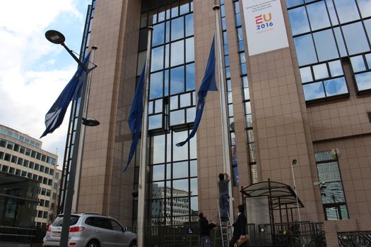 BELGIUM, Brussels: Flags outside the Council of the European Union in Brussels, Belgium are lowered following the deadly attacks at Maelbeek metro station and Zaventem airport on March 22, 2016. The attacks, at least one of which was carried out by a suicide bomber, left at least 30 dead, and scores more injured.