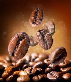 Grains of roasted coffee on an orange background