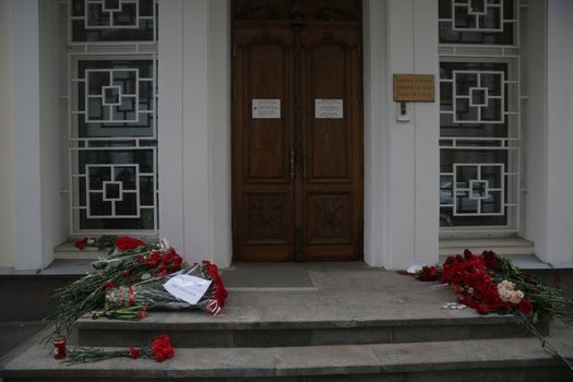 RUSSIA, Moscow: A makeshift memorial has taken shape at the Belgian Embassy in Moscow, Russia following the terror attacks that left at least 30 dead and hundreds injured in Brussels, Belgium on March 22, 2016. The Islamic State terror group has taken responsibility for the attacks, which brought death and destruction on Zaventem airport and Maelbeek metro station.