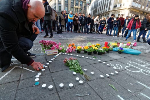BELGIUM, Brussels: A man lights a candle in Brussels on March 22, 2016 in tribute to the victims of the attacks that hit the Belgian capital that same day.