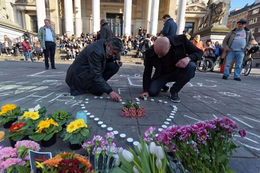 BELGIUM, Brussels: A man lights a candle in Brussels on March 22, 2016 in tribute to the victims of the attacks that hit the Belgian capital that same day.