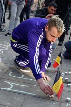 BELGIUM, Brussels: A man lights a candle in Brussels on March 22, 2016 in tribute to the victims of the attacks that hit the Belgian capital that same day.
