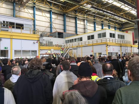 BELGIUM, Brussels: Passengers listen as a man speaks to them in a hangar at Zaventem airport on March 22, 2016, after terrorist bombings killed at least 30 people, both at the airport and at Maelbeek metro station.Pictures show hundreds of passengers stranded after the attack.