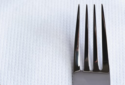 Fork close up on white napkin