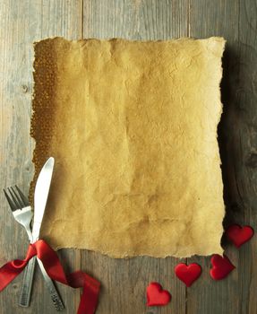 Valentine menu background made from red ribbon bow with cutlery and baubles