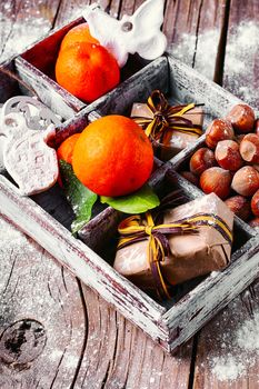 Vintage light box with Mandarin,hazelnuts and packaged gift