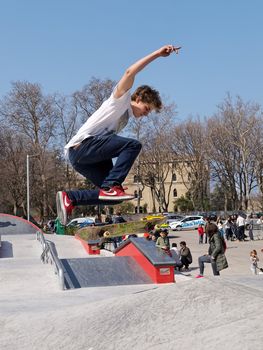 PULA, CROATIA - MARCH 19, 2016: Unidentified skateboarder doing a slide jump during the opening new Skate-park in Pula, Croatia on March 19, 2016.