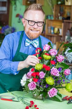 Single handsome man creating a flower arrangement