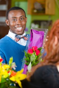 Dapper man purchasing roses at a florist shop