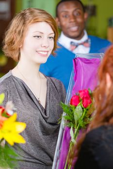 Teenager buying roses at a florist shop