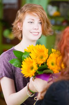 Teenager buying sunflowers at a florist shop