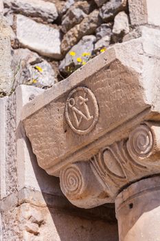 Ancient Christian symbol carved into stone column header