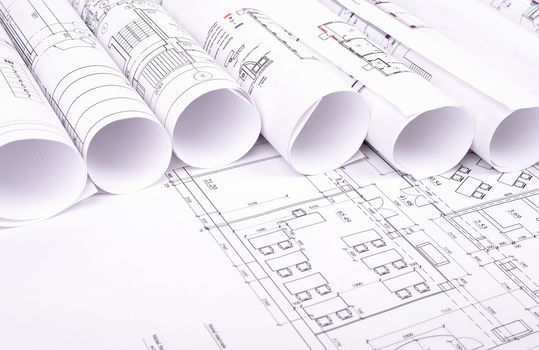 Blueprints and rolls of blueprints, close up view. Building concept