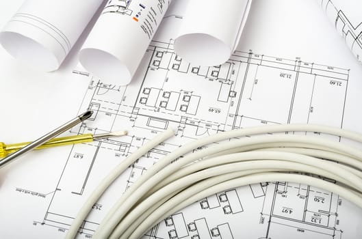 Architecture plan and rolls of blueprints with cable. Building concept