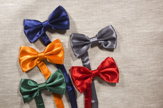 Set the bow tie in different colors for the celebration on a gray background