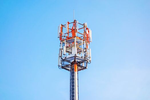 Cell tower and radio antenna, blue sky background