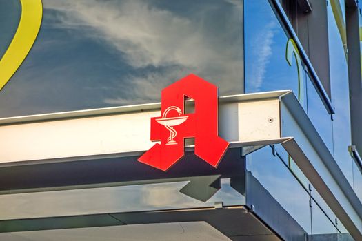 Winnenden, Germany - December 22, 2015: Sign for a German pharmacy (Apotheke) on new modern building facade of the hospital campus complex.